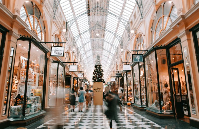 Holiday Shopping - person walking inside building near glass