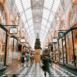 person-walking-inside-building-near-glass